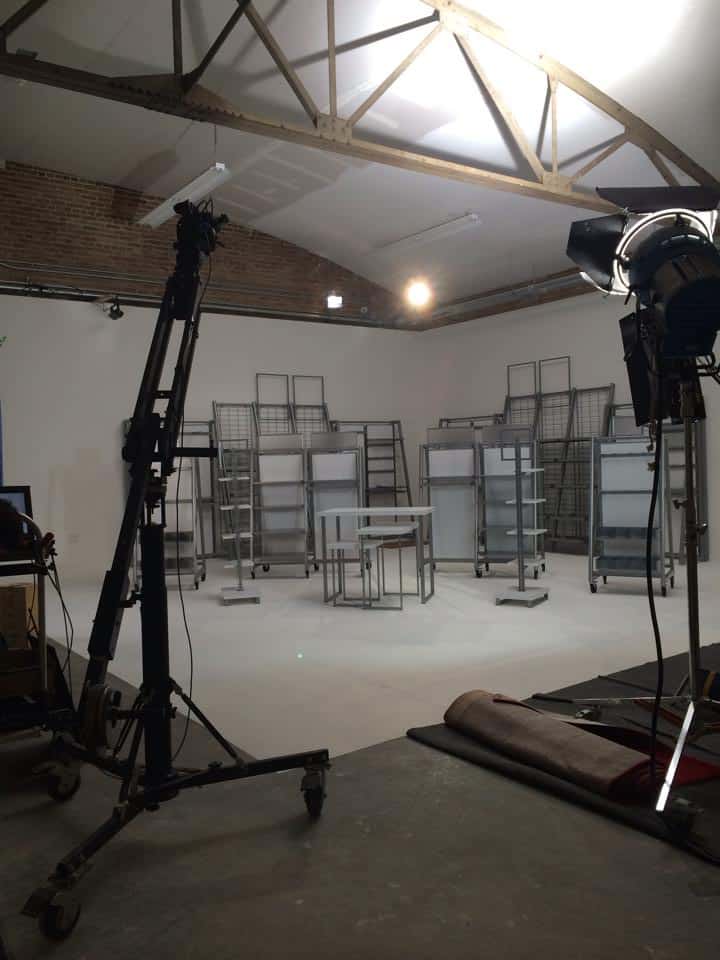 A film studio set lined with metal cases and tables
