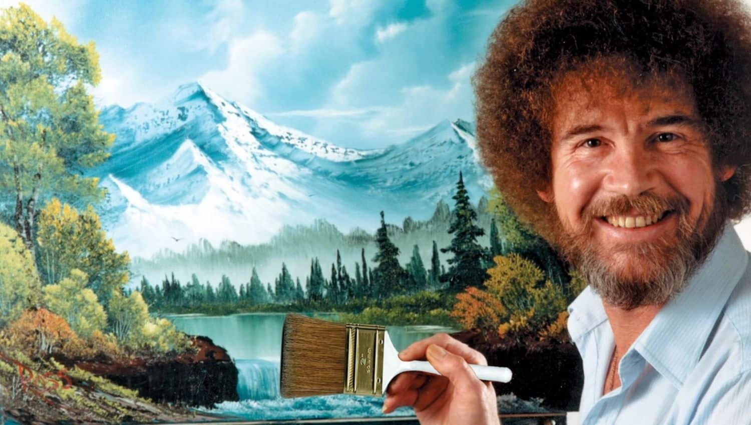 A middle aged Caucasian man with a fro named Bob Ross paints a colorful mountain landscape and smiles