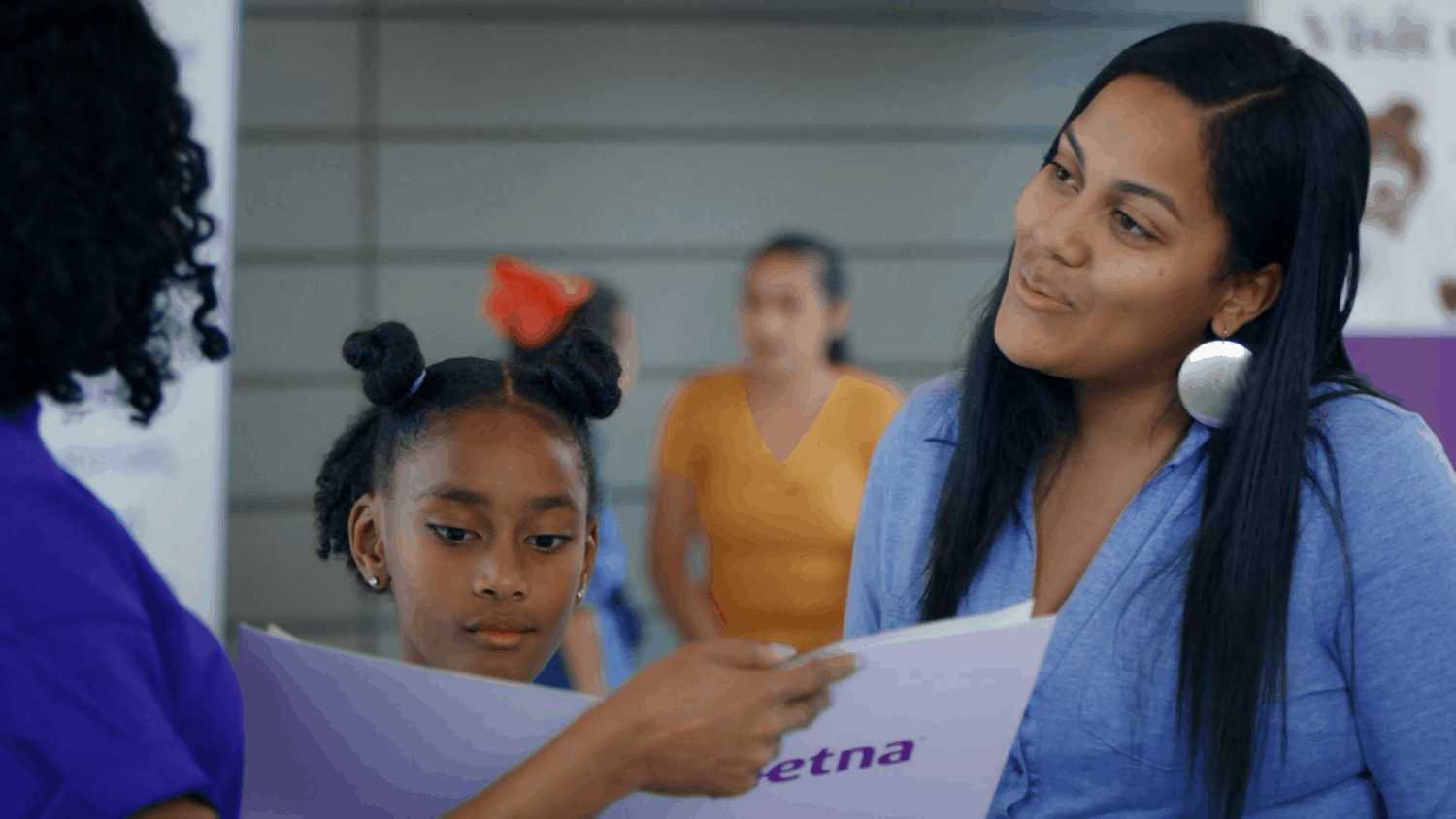 AETNA healthcare member reads over plans with her daughter