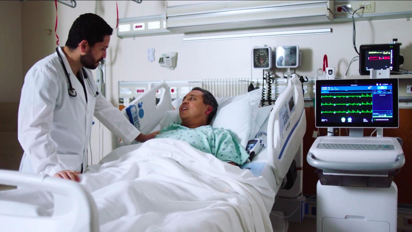 Doctor attends to patient in bed for a marketing video